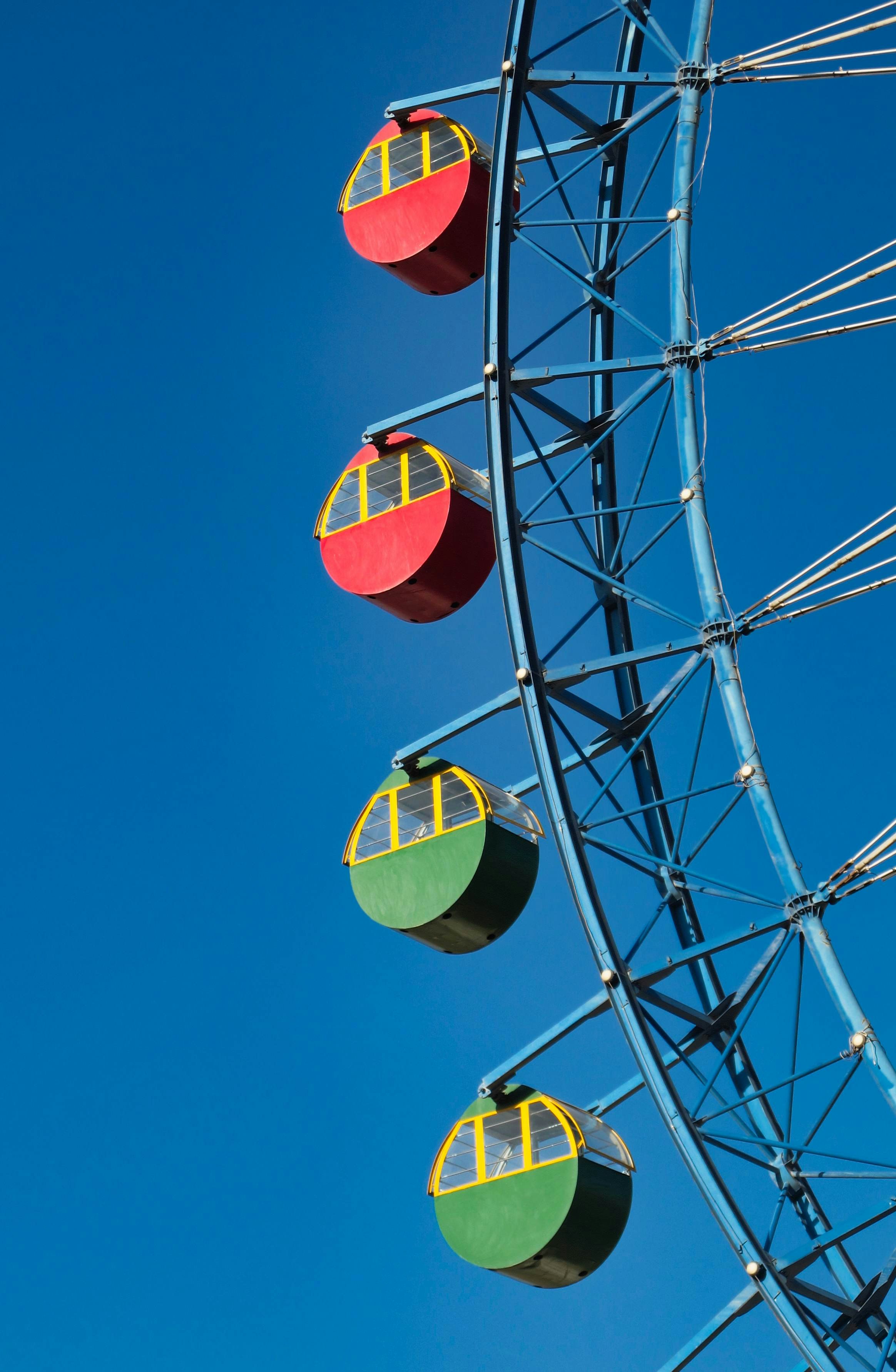 yellow red and black ferris wheel under blue sky during daytime